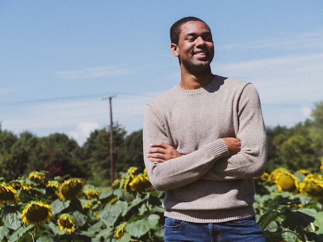 african american man smiling standing in a field