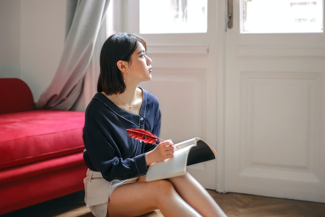 woman sitting on the floor writing in her journal